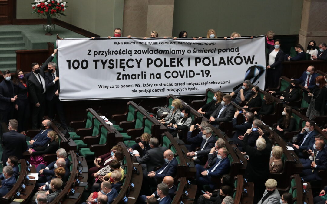 Opposition MPs unfurl banner mourning Poland’s 100,000 Covid deaths