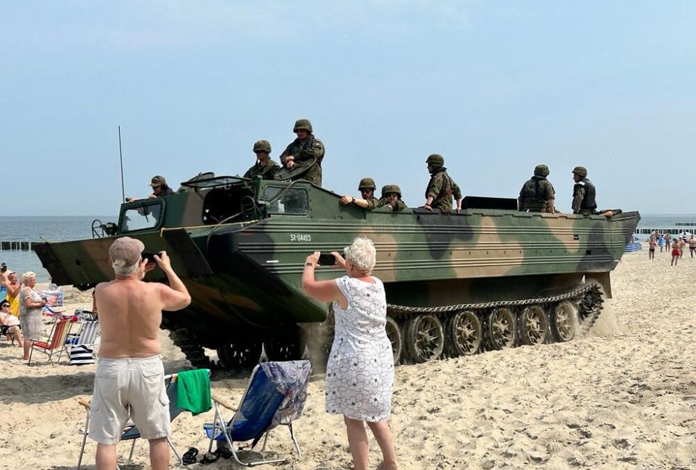 Polish beachgoers surprised as armoured vehicles emerge from sea