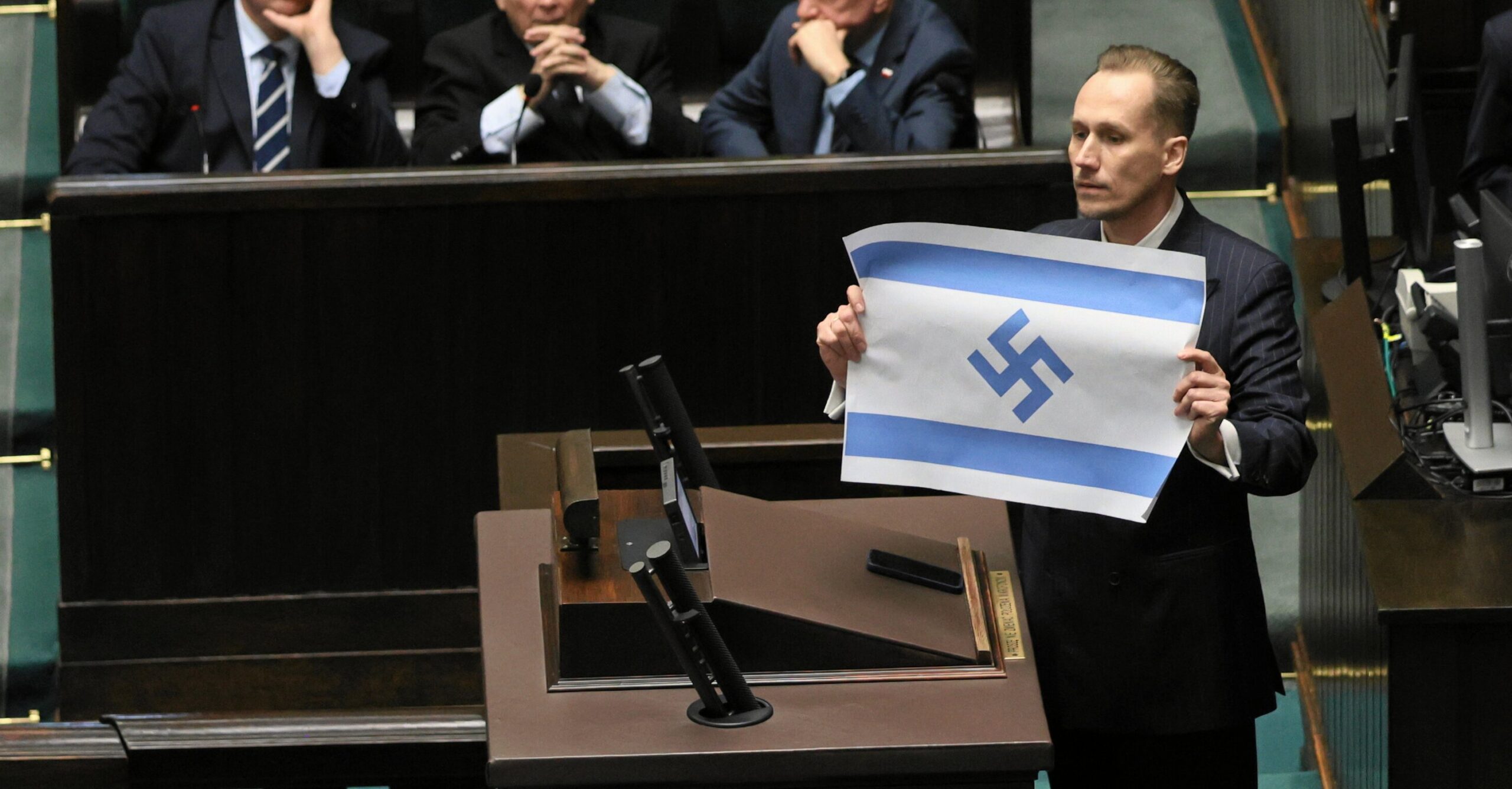 Far-right MP displays Israeli flag with swastika in Polish parliament